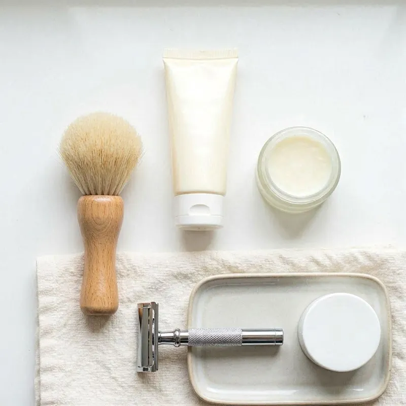 gentle shaving essentials for sensitive skin including a mild fragrance‑free shaving cream, a soft shaving brush, a safety razor with a clean blade, and a soothing hypoallergenic aftershave balm